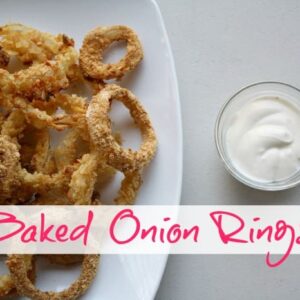 Overhead shot of onion rings on a white dish.