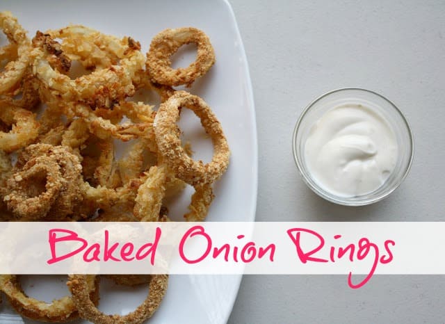 Baked Onion Rings on a white tray with dip.