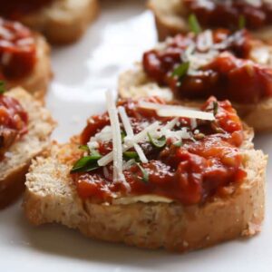 rows of Homemade Sundried Tomatoes Bruschetta on a white tray.