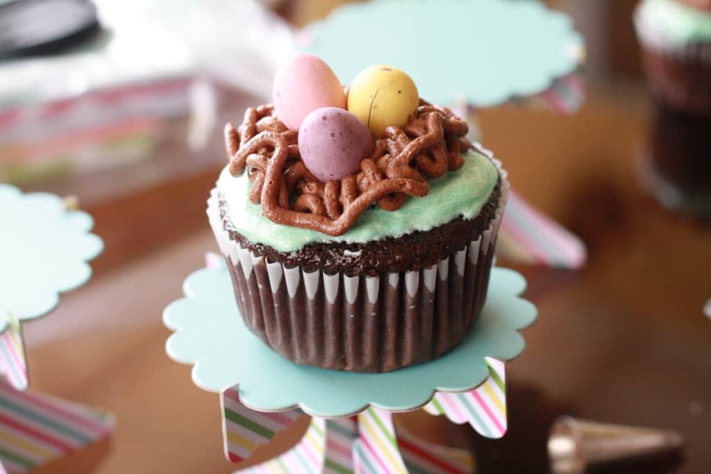 Bird's nest easter cupcakes with chocolate eggs on top.