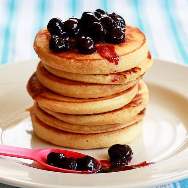 Stack of vanilla pancakes with blueberry sauce.