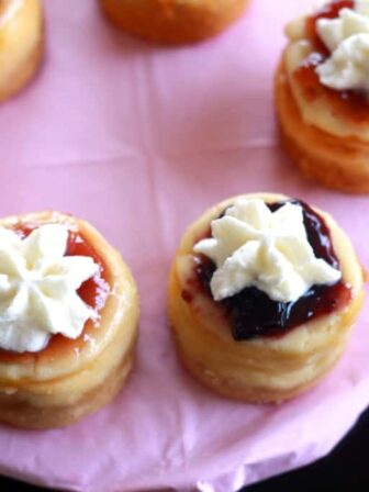 Overhead shot of mini cheesecakes on a cake stand.