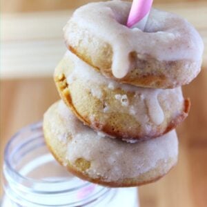 Doughnuts around a pink straw.