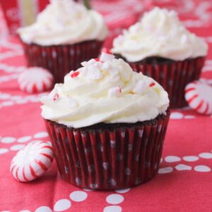 A row of three cupcakes on a table.