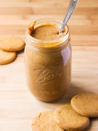 Side on shot of cookie butter in a glass jar.