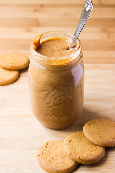 Side shot of cookie butter in a jar, with cookies. 
