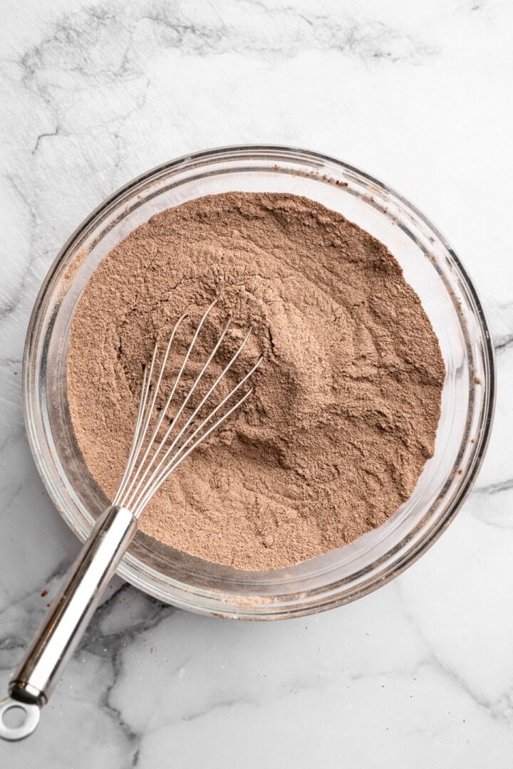 Whisk in bowl with dry ingredients for chocolate peppermint cupcakes.