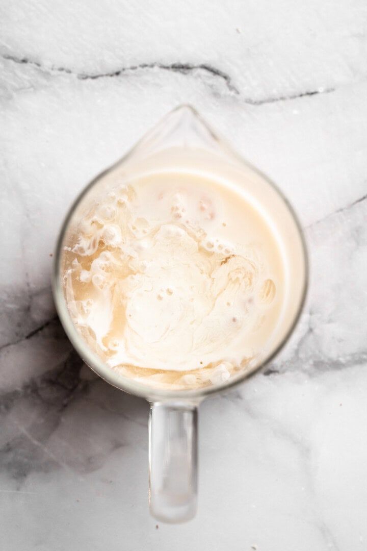 Vegan buttermilk mixture in liquid measuring cup.