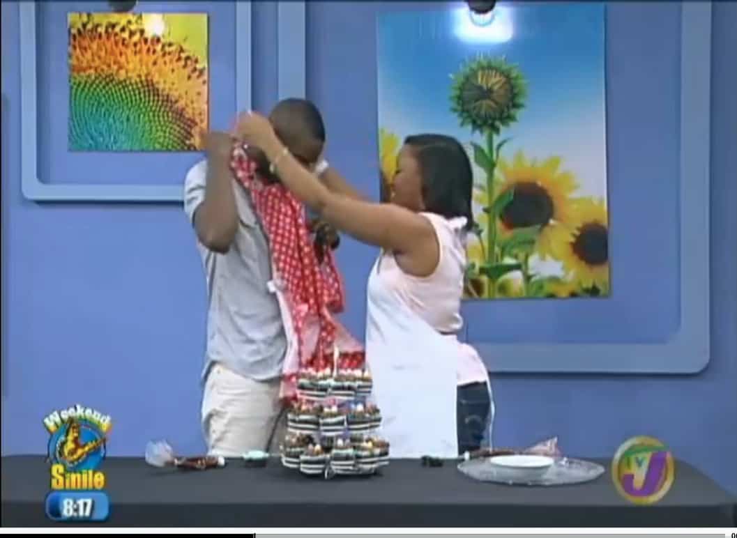 Jessiker Bakes putting an apron on presenter.