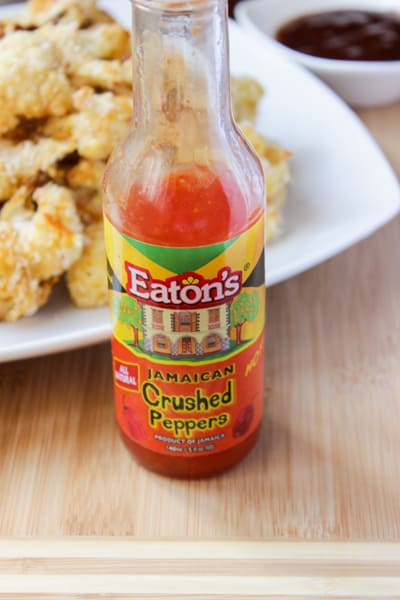 Bottle of hot sauce on a table.