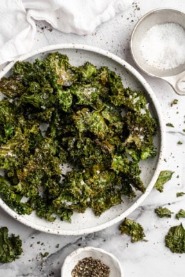 Bowl of baked kale chips with sea salt.