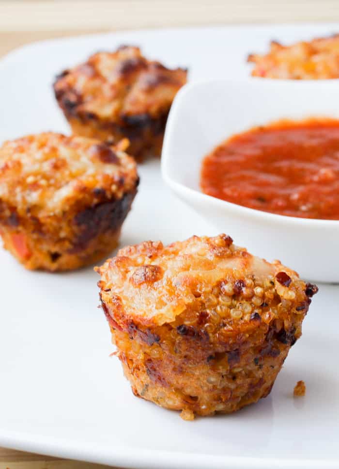 Quinoa pizza bites on a white plate.