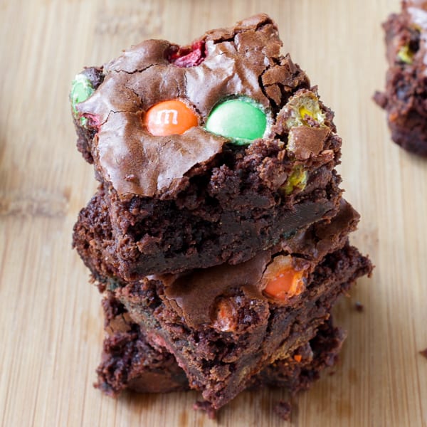 Close up of Double Chocolate M&M Brownies on a wooden table.