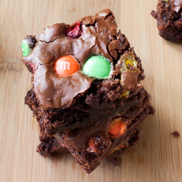 Overhead shot of Double Chocolate M&M Brownies on a wooden table.