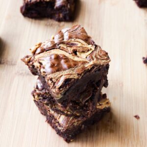 Stakc of peanut butter swirl brownies.