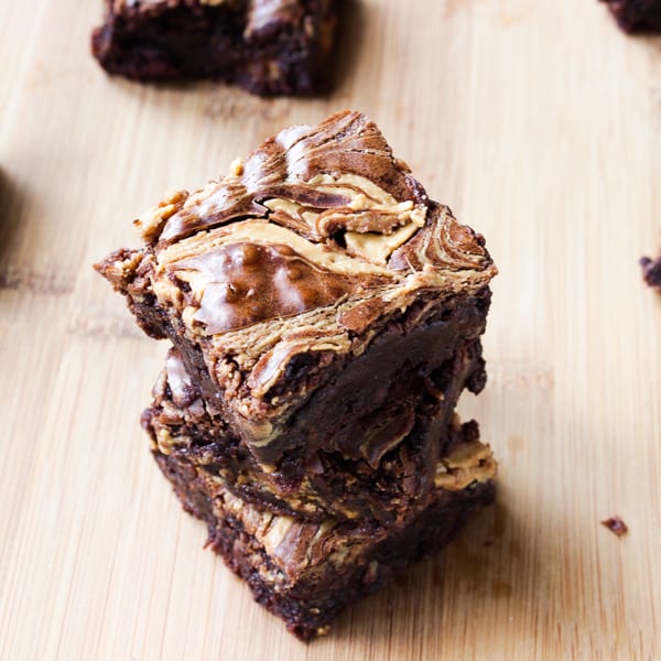 Stack of peanut butter brownies on a wood table.