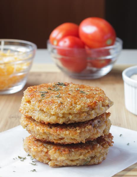 Side shot of veggie burgers on a wooden table. 