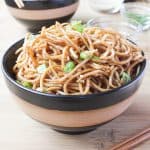 Sesame Noodles with Honey Ginger Sauce in a black and brown bowl.