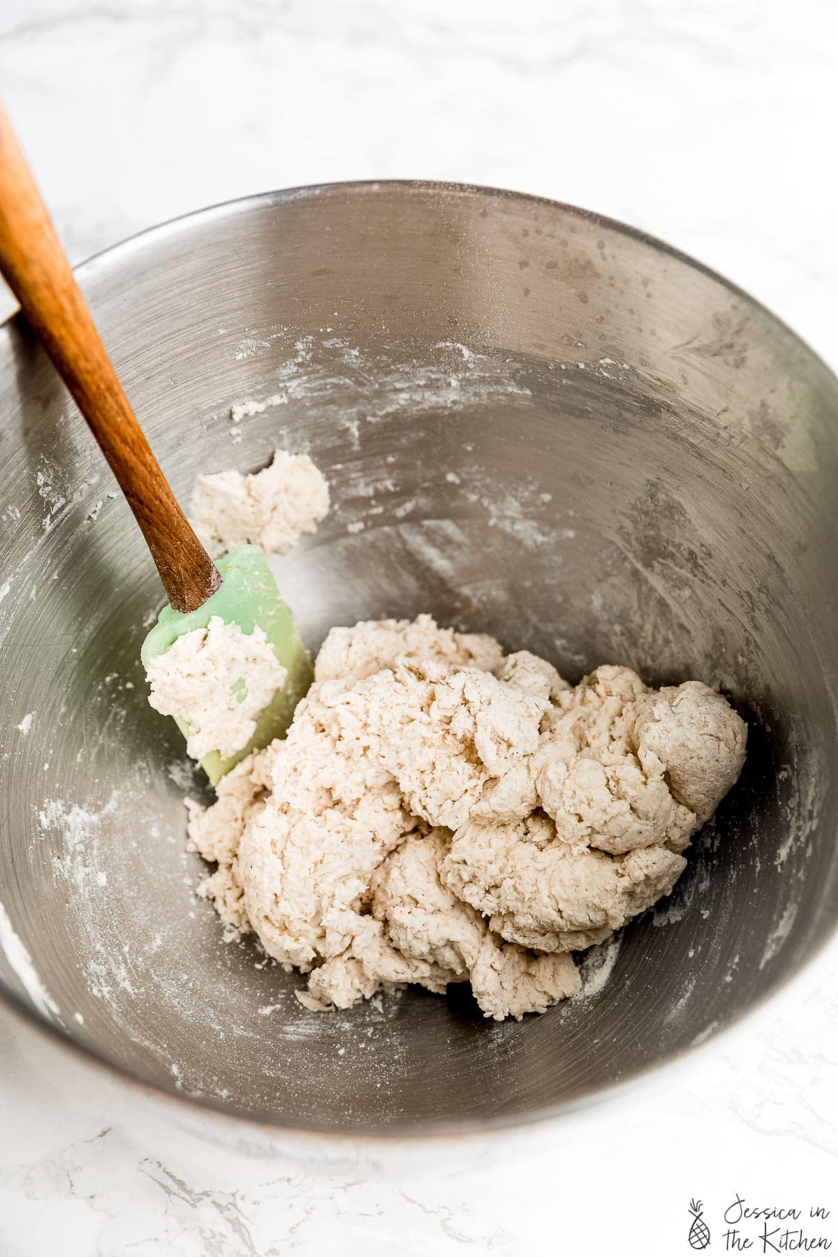 Dough being mixed in a bowl.