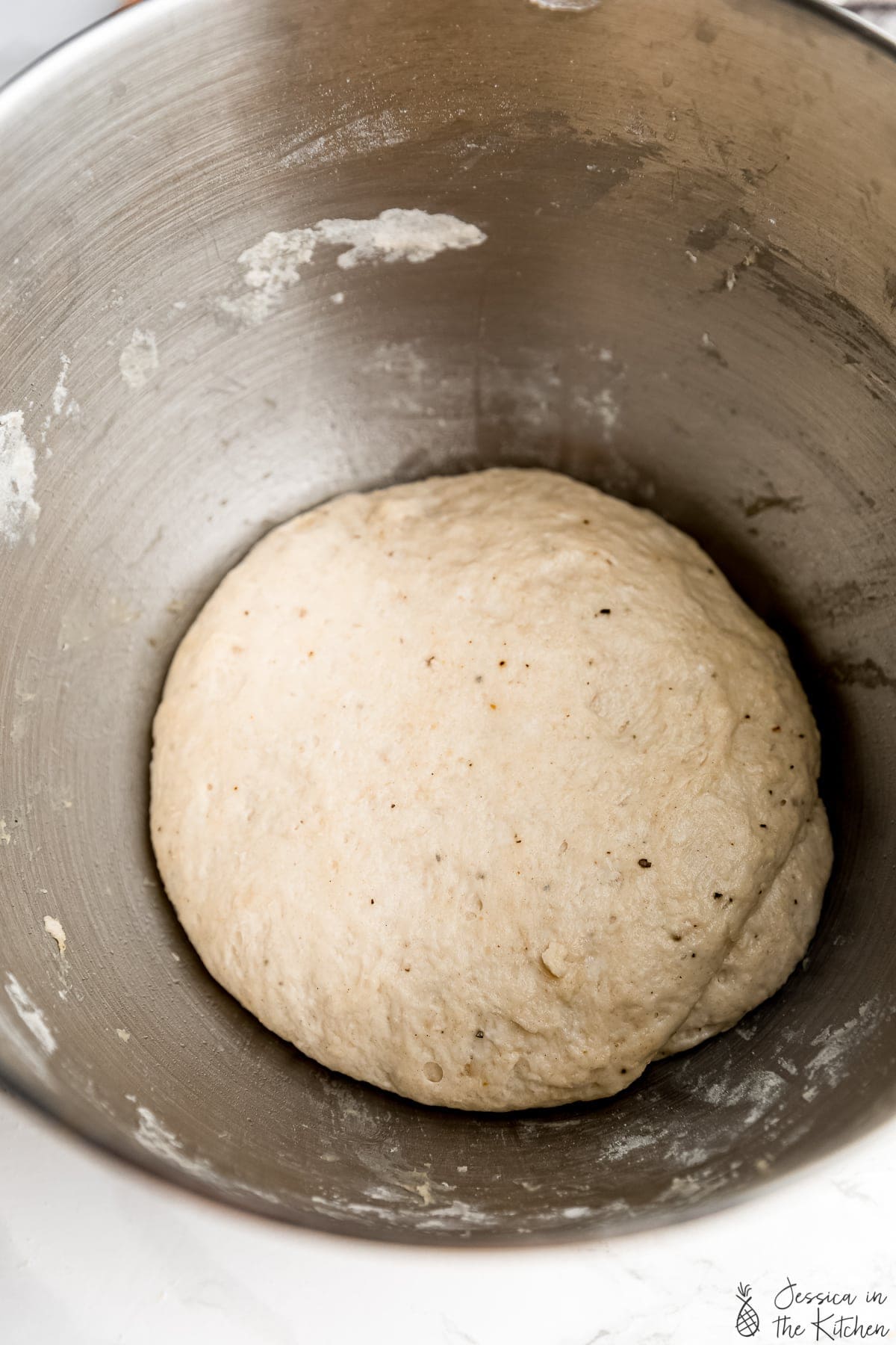 Smoothed dough in a mixing bowl.