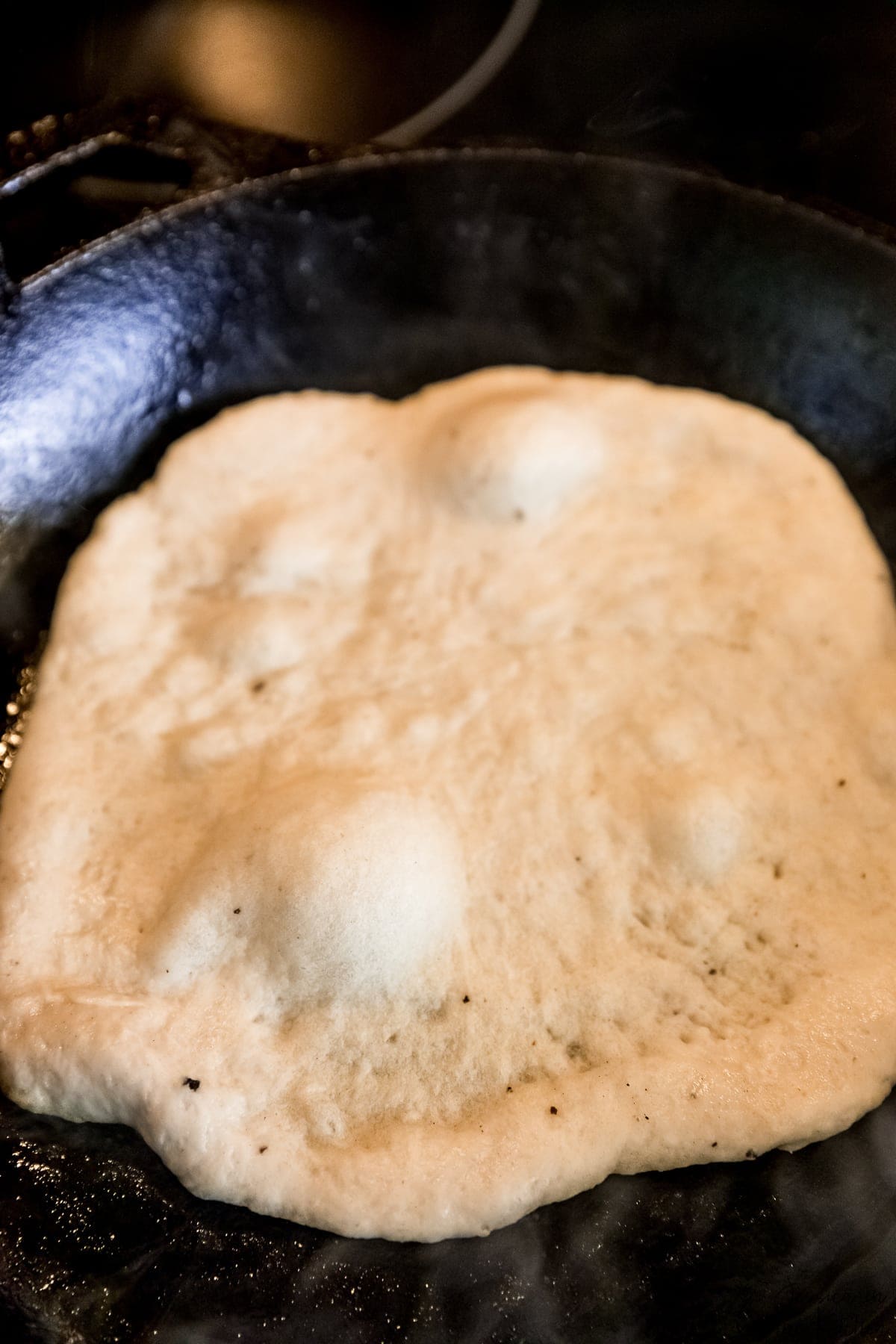Naan dough in a cast iron skillet.