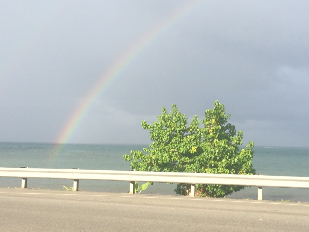 Beach in Portland, Jamaica with a rainbow over the sea.