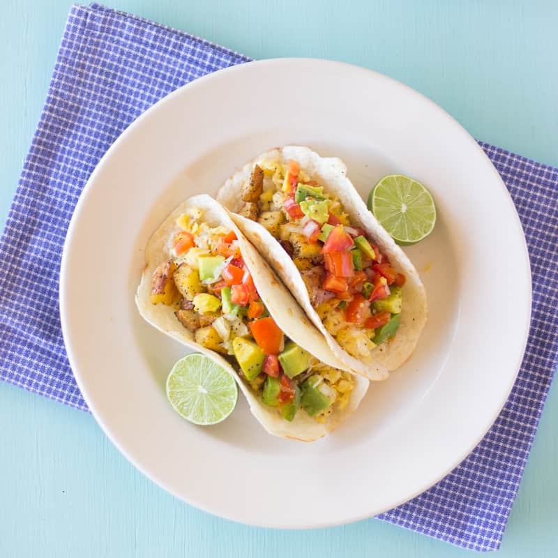 Overhead shot of breakfast tacos with avocado pico de gallo salsa.