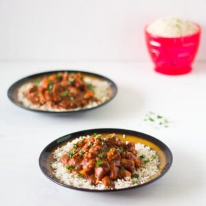 Healthy Indian Butter Chicken on a bed of rice in a plate.