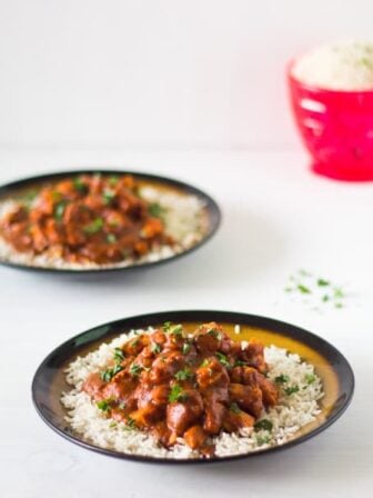 Healthy Indian Butter Chicken on a bed of rice in a plate.