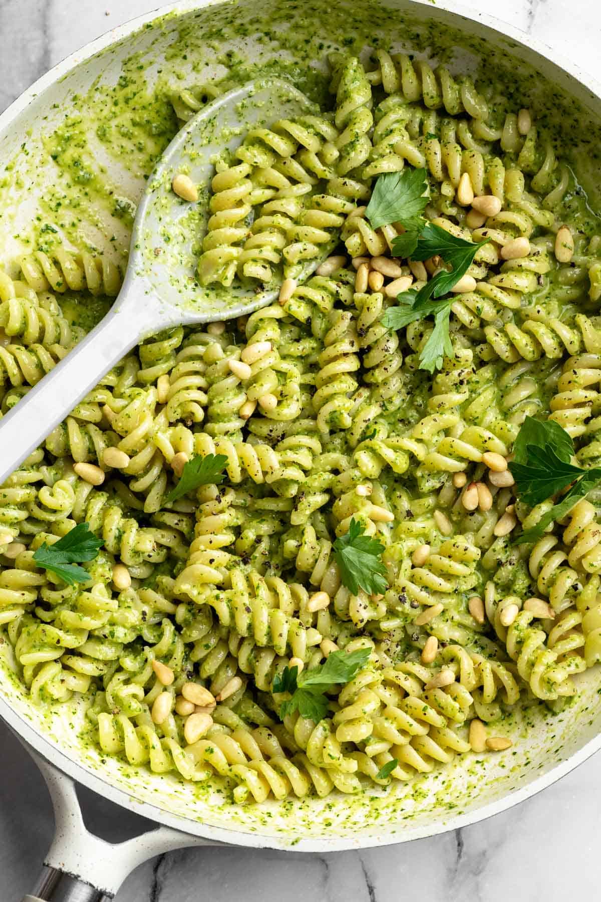 Pasta with parsley pesto in skillet.