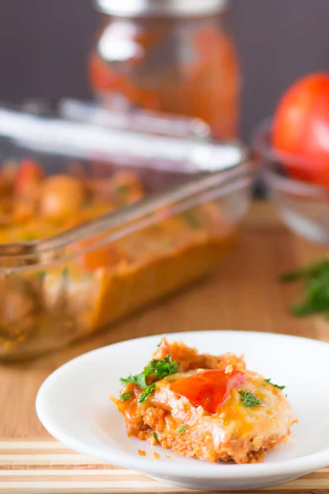 Slice of cheesy quinoa casserole on a white plate.