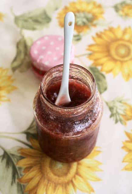 Homemade strawberry jam in a glass jar.