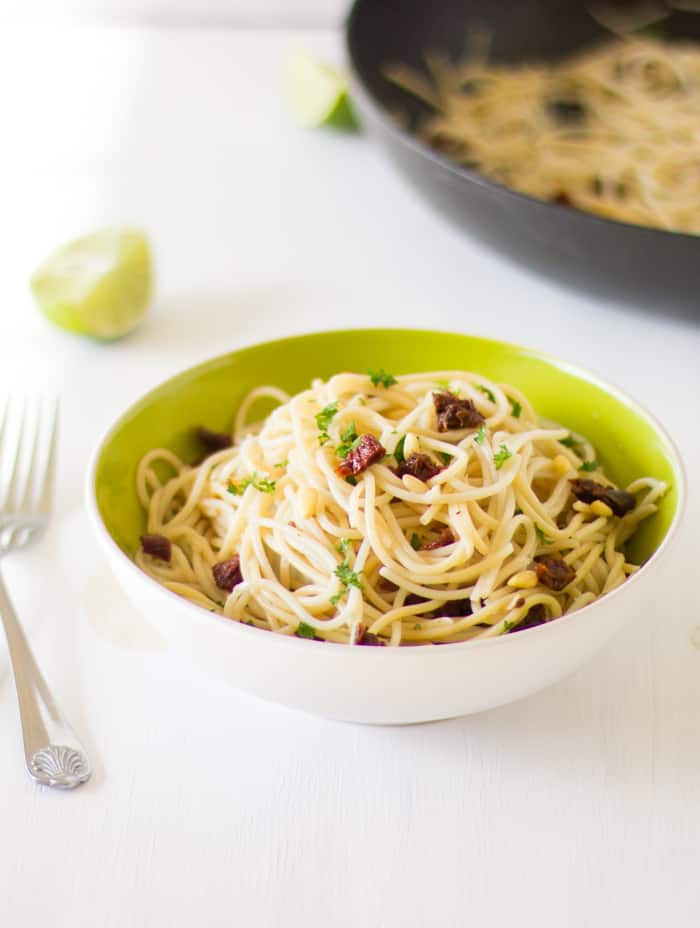 Lemon Garlic Spaghetti in a green bowl with a fork.