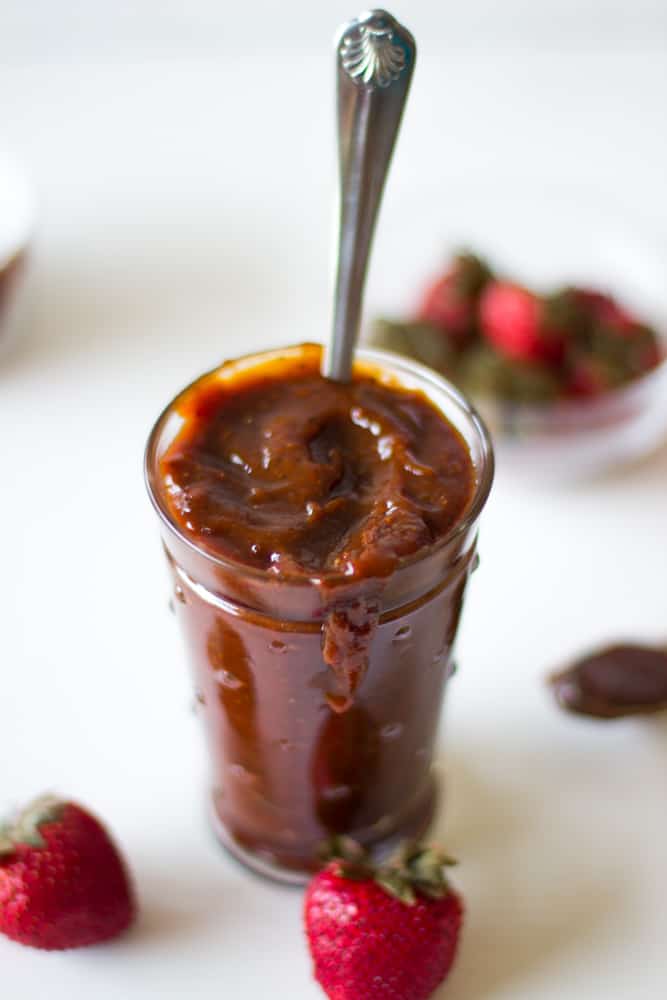Side shot of roasted strawberry barbecue sauce in a glass jar.