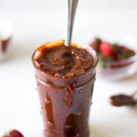 Side shot of BBQ sauce in a glass jar.