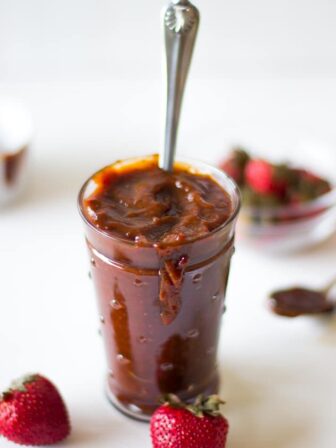 Side shot of BBQ sauce in a glass jar.
