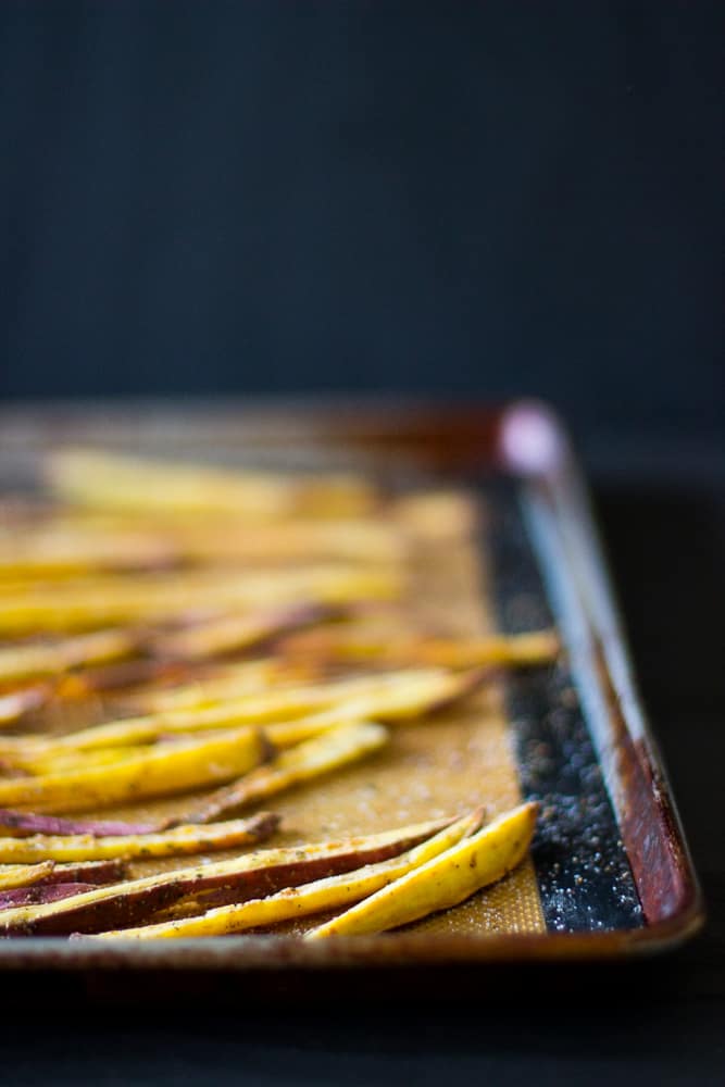 Sweet potato fries on a baking sheet.