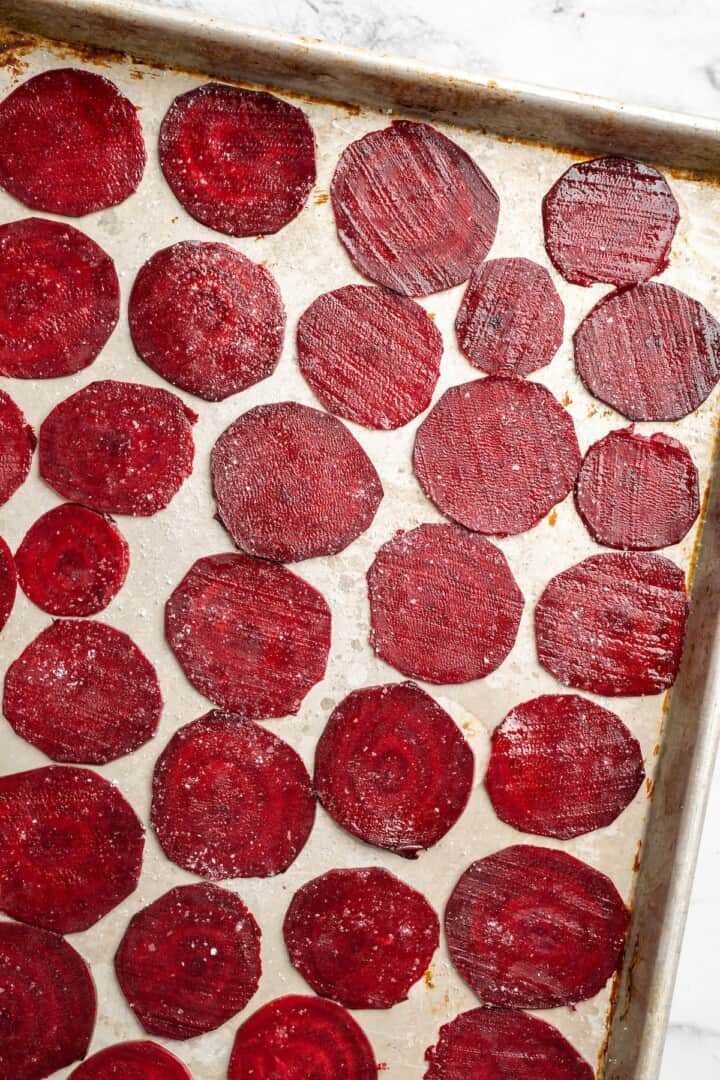 Overhead view of raw beets on sheet pan