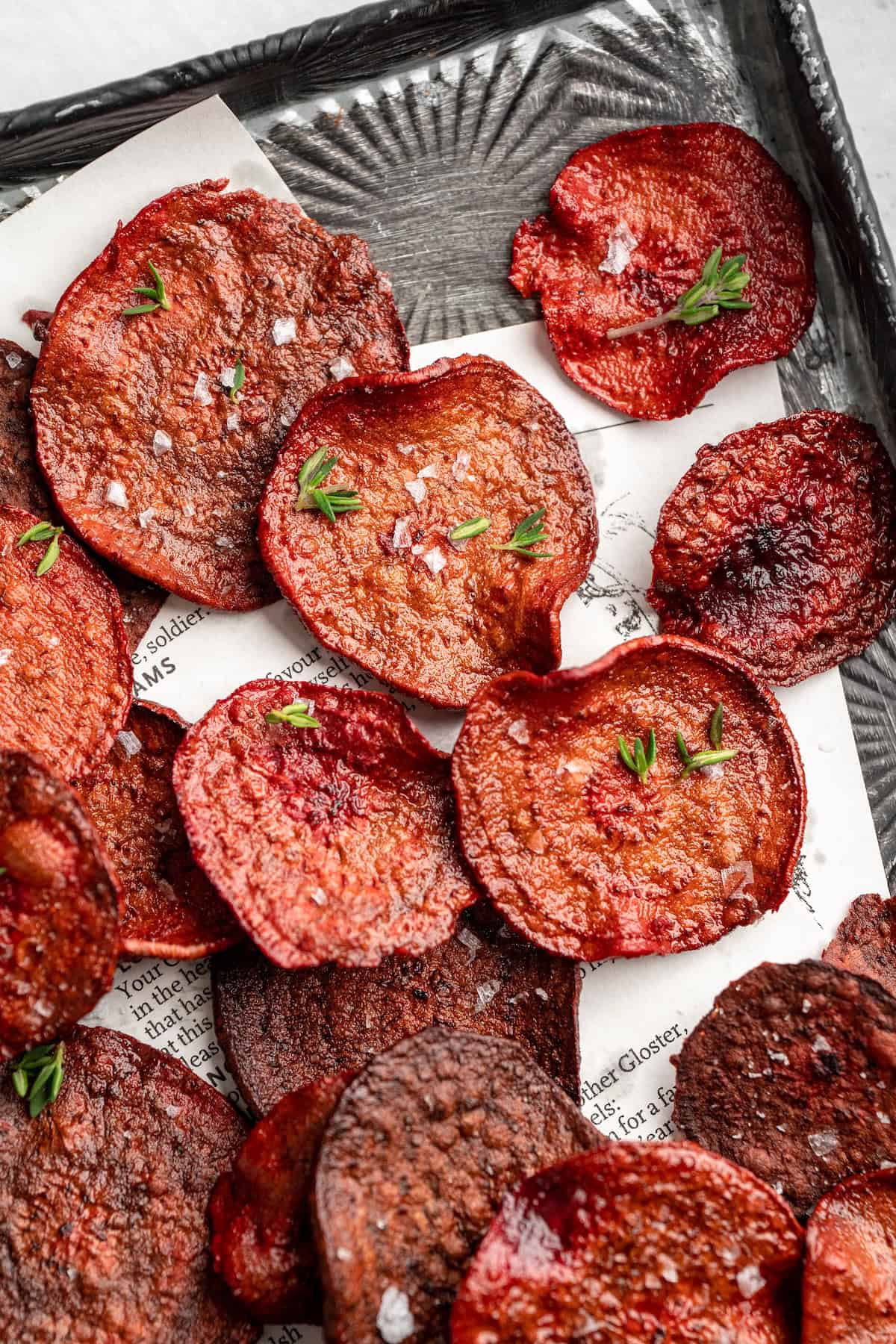 Overhead view of beet chips on baking sheet
