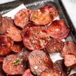 Overhead view of crispy beet chips on sheet pan