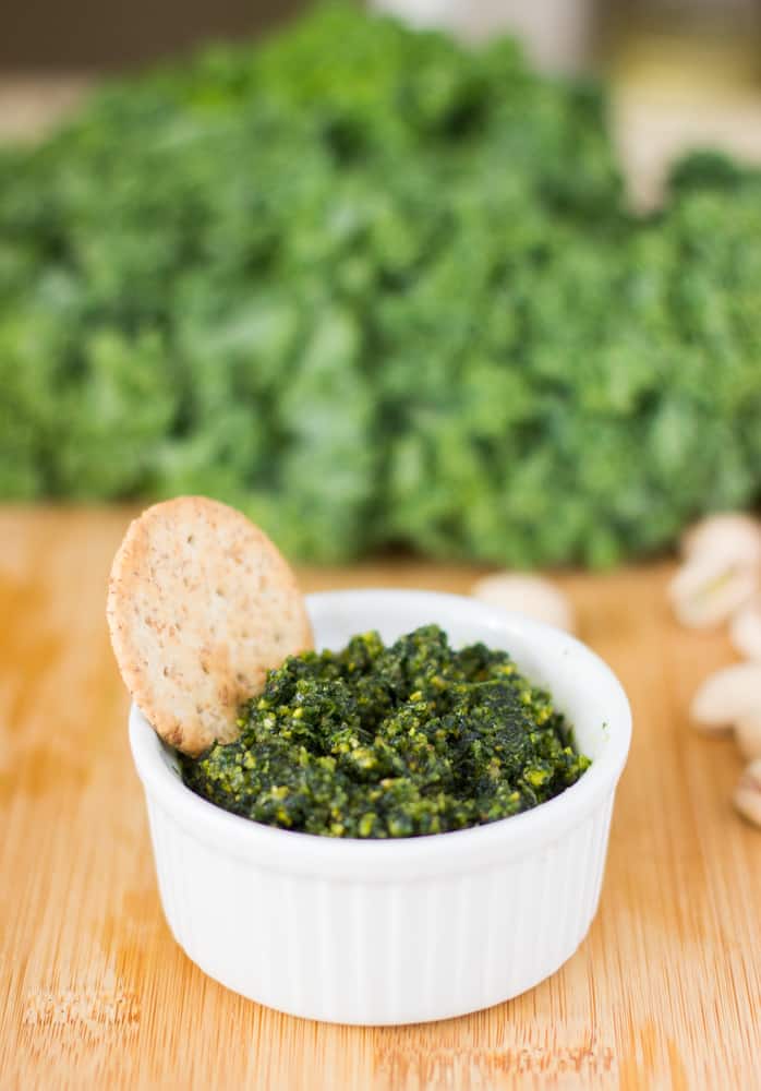 Kale and pistachio pesto in a white ramekin.