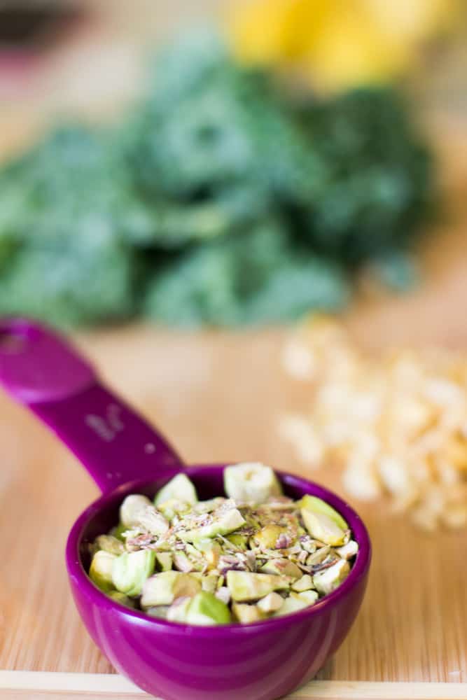 Pistachio nuts in a purple scoops.