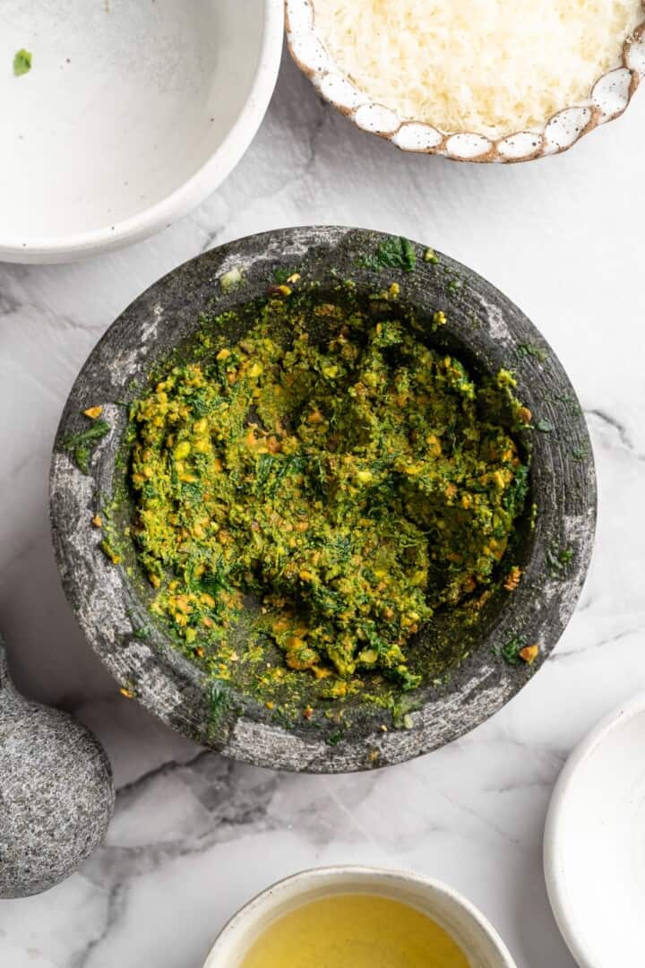 Overhead view of pistachio pesto in mortar before adding cheese and oil - 12