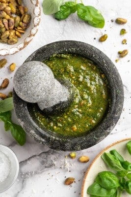 Overhead view of pistachio pesto in mortar and pestle
