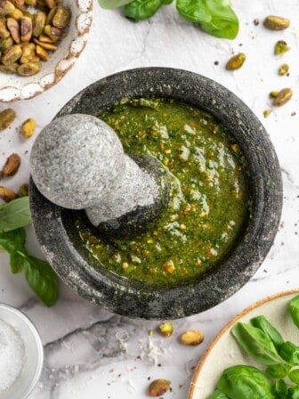 Overhead view of pistachio pesto in mortar and pestle