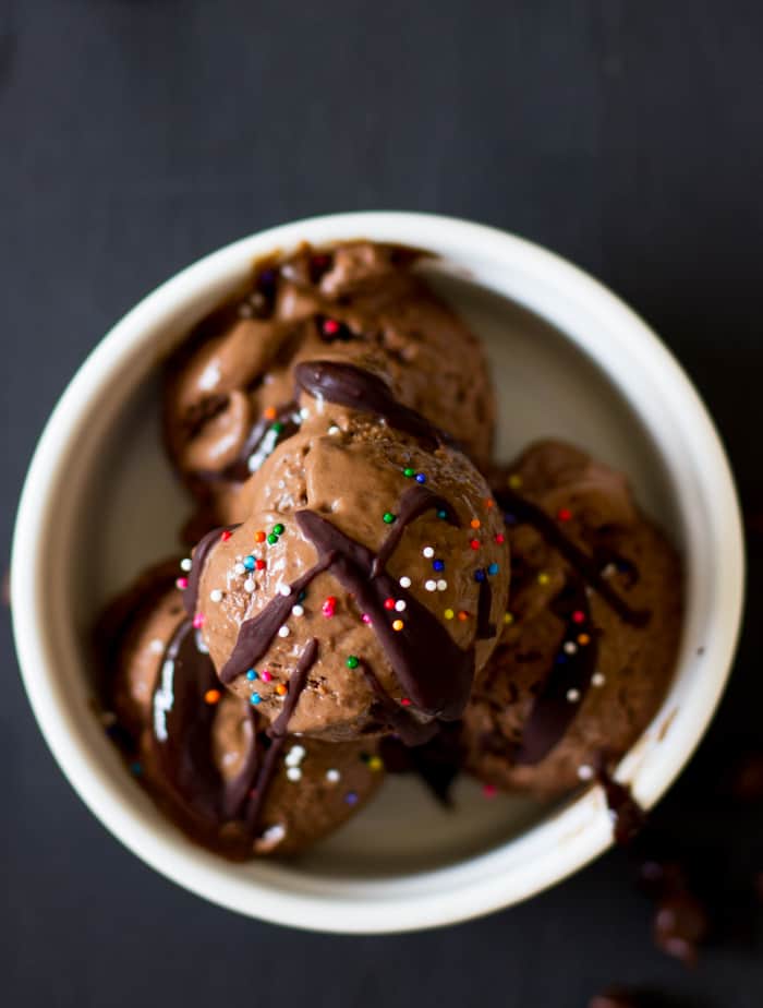 Overhead shot of Vegan creamy chocolate avocado ice cream in a white bowl.