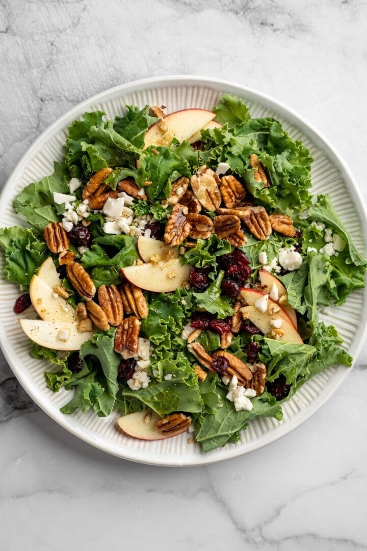 Overhead view of apple, pecan, and vegan feta salad on plate