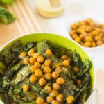 Kale and chickpea salad in a green bowl.