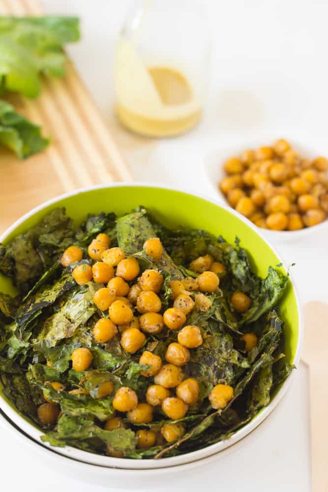 Close up of chickpea salad in a green bowl. 