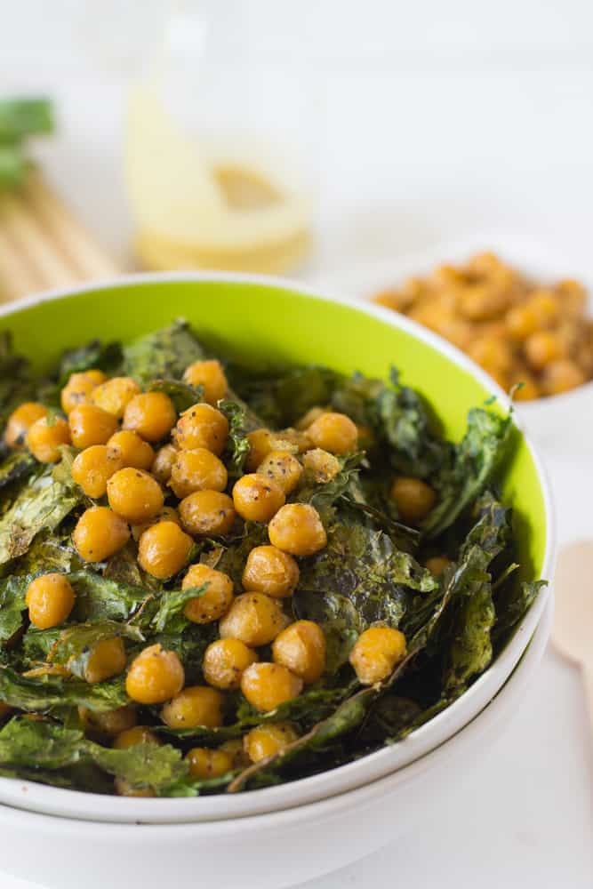 Close up of crunchy kale & chickpea Salad in a green bowl. 